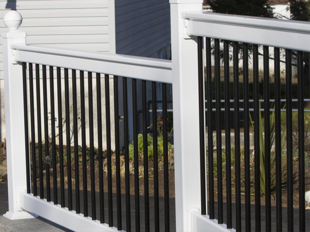 A white vinyl fence with black balusters